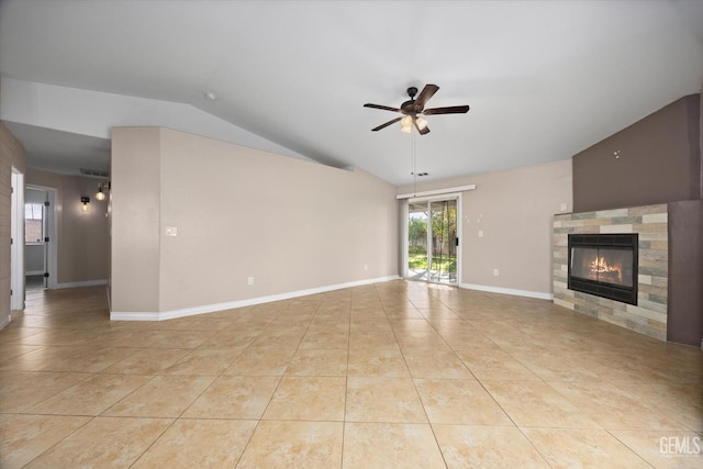 unfurnished living room featuring ceiling fan, a tiled fireplace, lofted ceiling, and tile patterned floors