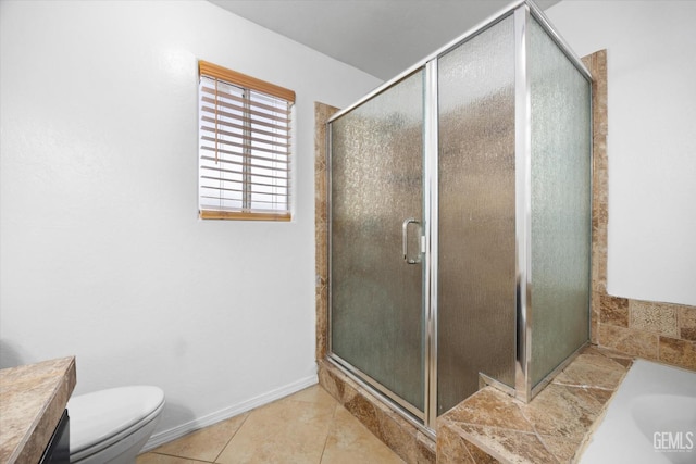 full bath featuring a garden tub, toilet, baseboards, tile patterned floors, and a stall shower