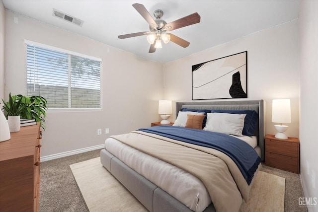 carpeted bedroom with ceiling fan, visible vents, and baseboards