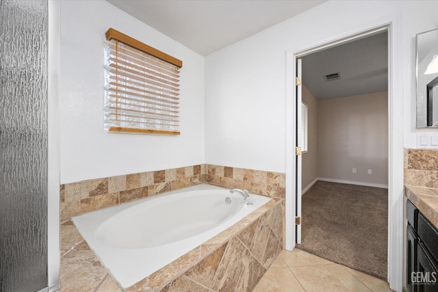 bathroom with a garden tub, visible vents, and tile patterned floors