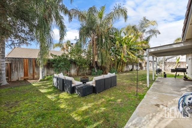 view of yard with an outdoor fire pit, a patio area, and a fenced backyard