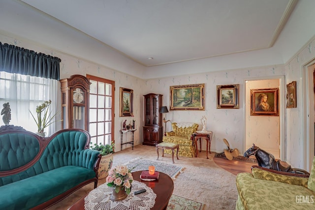 living area featuring wallpapered walls and carpet floors