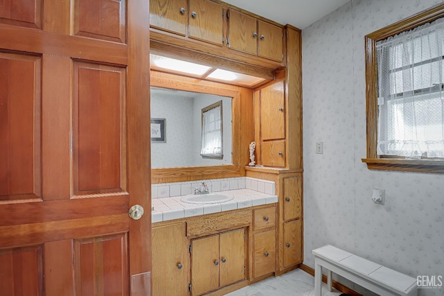 bathroom featuring wallpapered walls, vanity, and marble finish floor