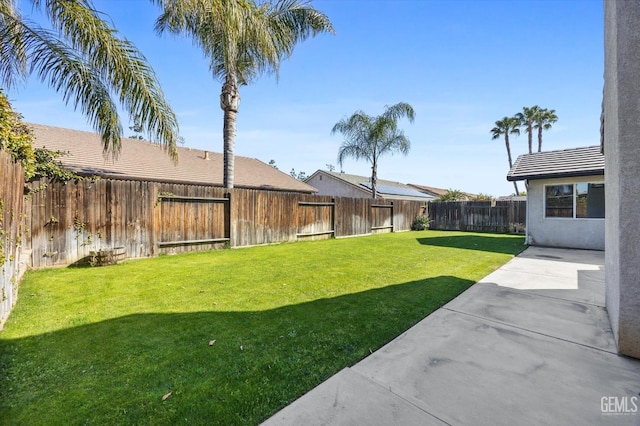 view of yard featuring a patio area and a fenced backyard