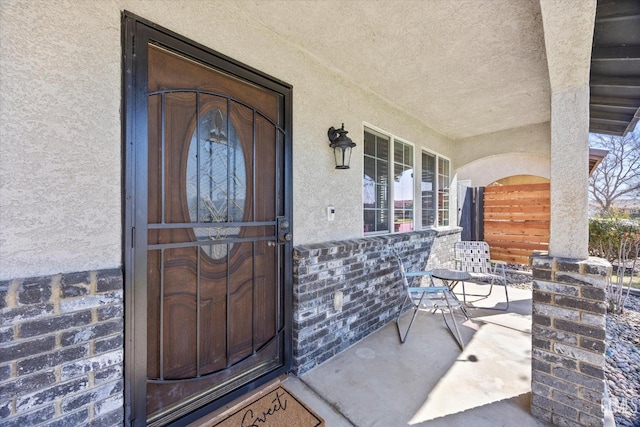 entrance to property featuring stucco siding