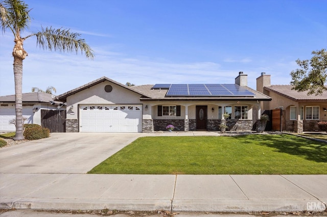 ranch-style house with solar panels, stucco siding, an attached garage, driveway, and a front lawn