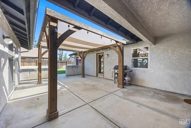 view of patio / terrace featuring fence and a grill