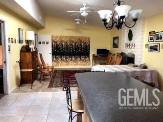 interior space with ceiling fan and light tile patterned flooring