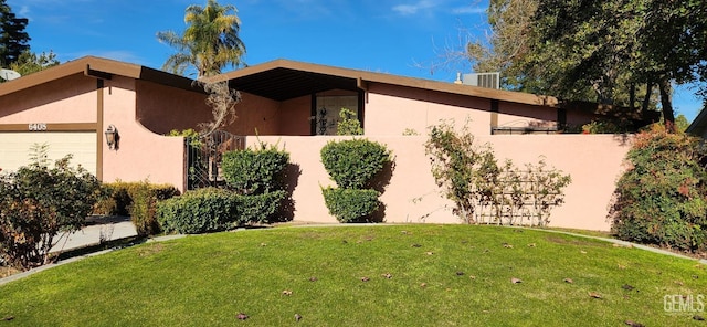 view of home's exterior with a garage and a lawn