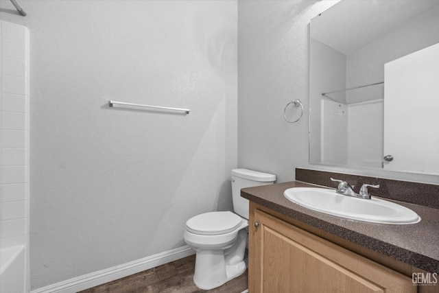 bathroom featuring vanity, hardwood / wood-style flooring, and toilet