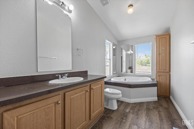 bathroom with a bathing tub, wood-type flooring, lofted ceiling, vanity, and toilet