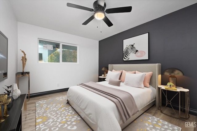 bedroom with hardwood / wood-style flooring and ceiling fan