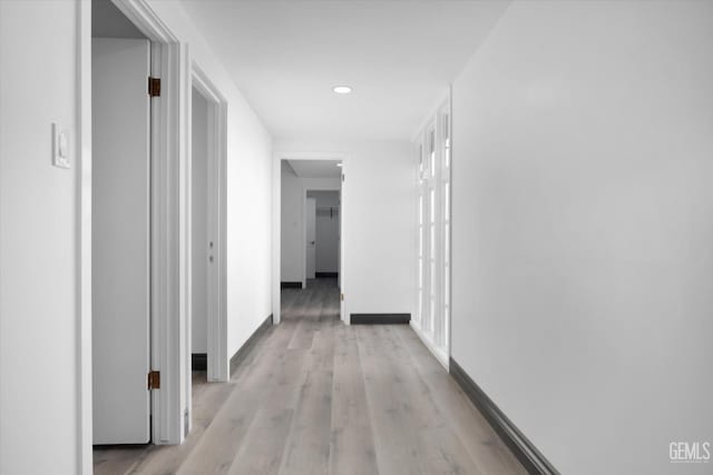 corridor with light hardwood / wood-style flooring