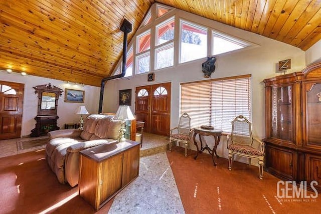 living room featuring high vaulted ceiling and wooden ceiling