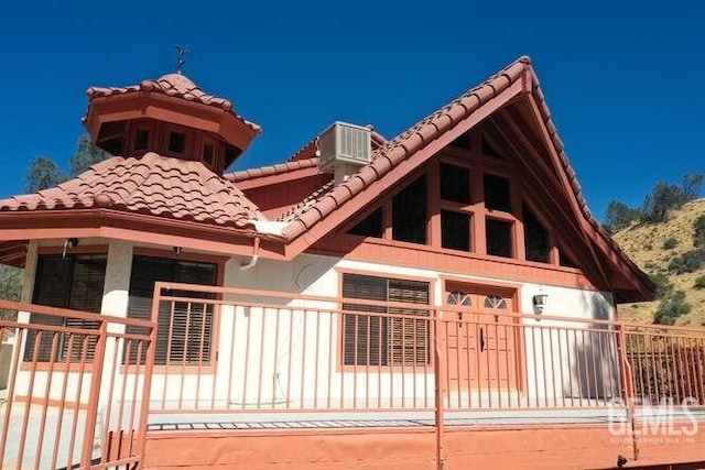 exterior space with a balcony and central AC unit