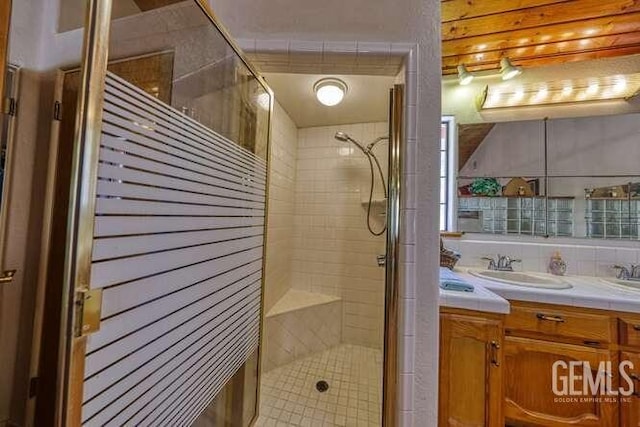 bathroom with vanity and a shower with door