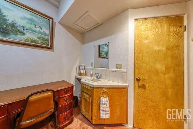 bathroom with decorative backsplash and vanity