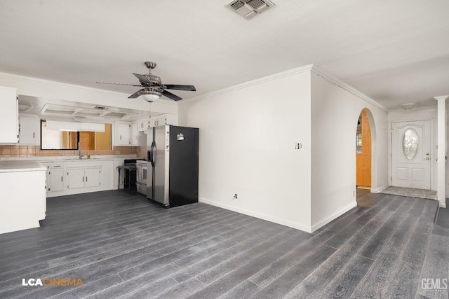 kitchen featuring white cabinets, crown molding, stainless steel refrigerator with ice dispenser, ceiling fan, and tasteful backsplash