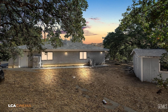 exterior space featuring a shed and central air condition unit