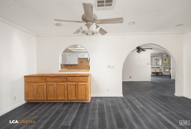 interior space featuring ceiling fan and crown molding