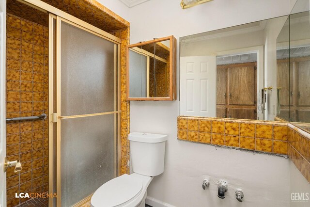 bathroom with an enclosed shower and toilet