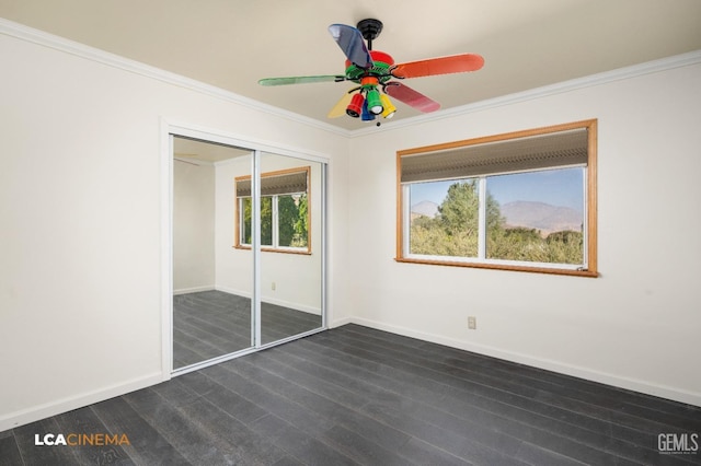 unfurnished bedroom featuring a closet, ceiling fan, and crown molding