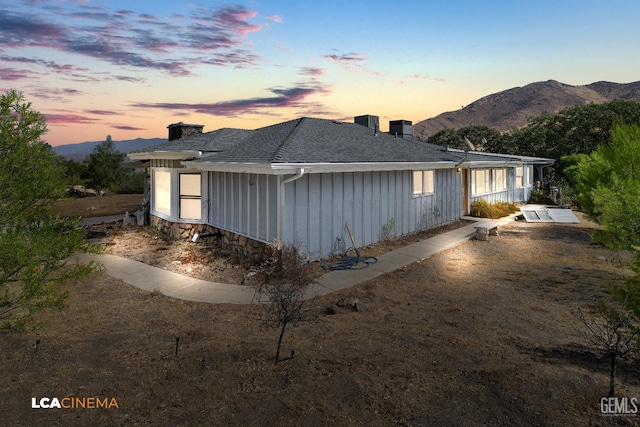 property exterior at dusk with a mountain view