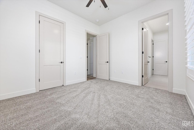 unfurnished bedroom with carpet flooring, baseboards, and ceiling fan