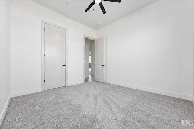 unfurnished bedroom with baseboards, carpet floors, and ceiling fan