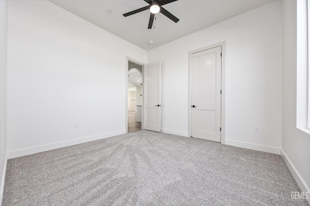 unfurnished bedroom with ceiling fan, baseboards, and carpet