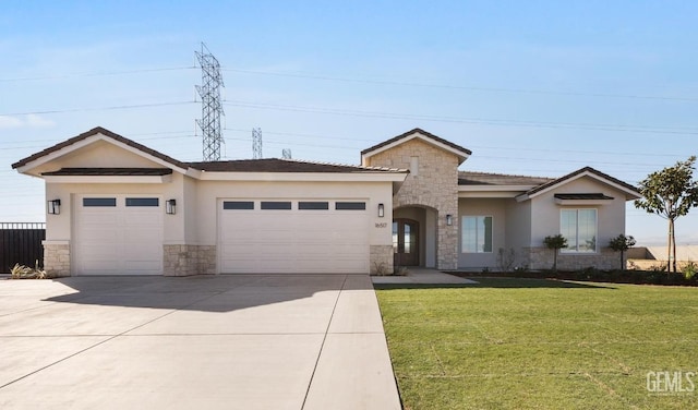 view of front of property featuring stucco siding, a front lawn, driveway, stone siding, and a garage