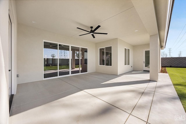 view of patio / terrace with a ceiling fan and fence