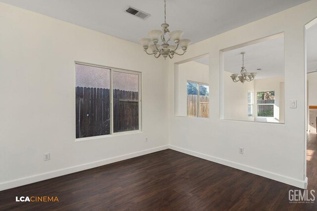9827 Metherly Hill Rd, Bakersfield, CA 93312 - empty room featuring a chandelier, dark wood-style floors, and baseboards