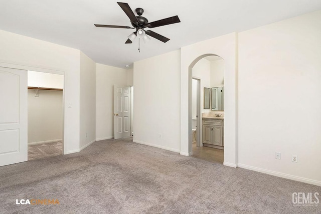 9827 Metherly Hill Rd, Bakersfield, CA 93312 - unfurnished bedroom featuring light carpet, arched walkways, a sink, and baseboards