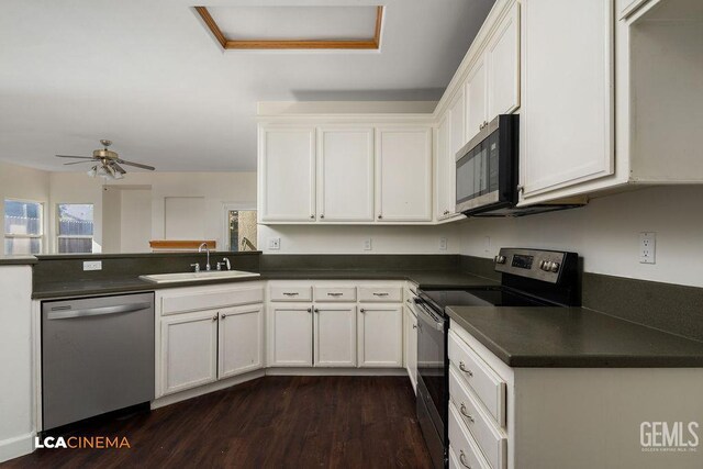 9827 Metherly Hill Rd, Bakersfield, CA 93312 - kitchen with stainless steel appliances, a sink, dark countertops, white cabinets, and dark wood-style floors