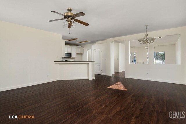 9827 Metherly Hill Rd, Bakersfield, CA 93312 - unfurnished living room with dark wood-type flooring, a chandelier, a ceiling fan, baseboards, and arched walkways