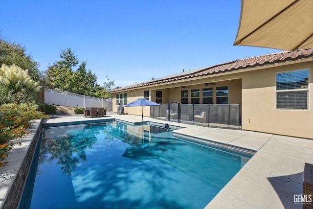 view of pool with a patio and ceiling fan