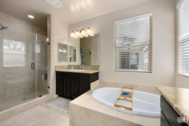 bathroom featuring vanity, tile patterned floors, and shower with separate bathtub