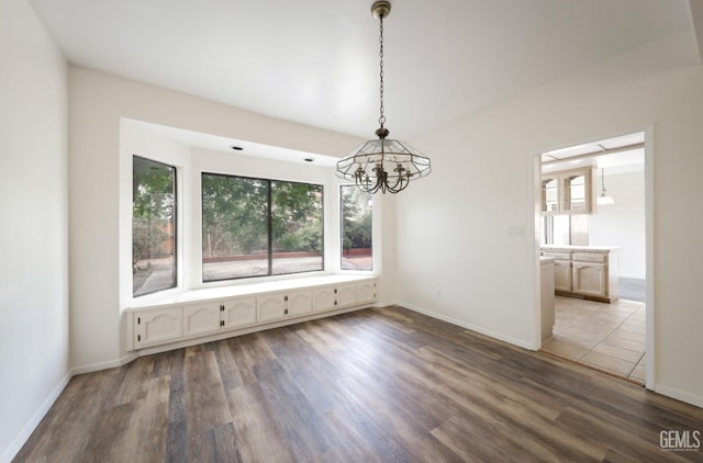 8226 Birmingham St, Bakersfield, CA 93311 - unfurnished dining area featuring a chandelier, wood finished floors, and baseboards