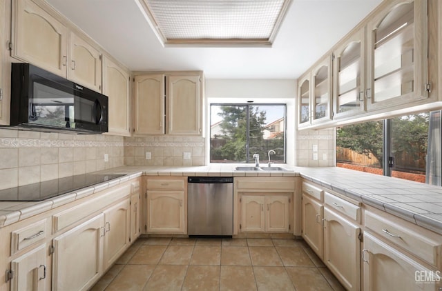 8226 Birmingham St, Bakersfield, CA 93311 - kitchen featuring black appliances, a sink, decorative backsplash, light tile patterned floors, and light brown cabinetry