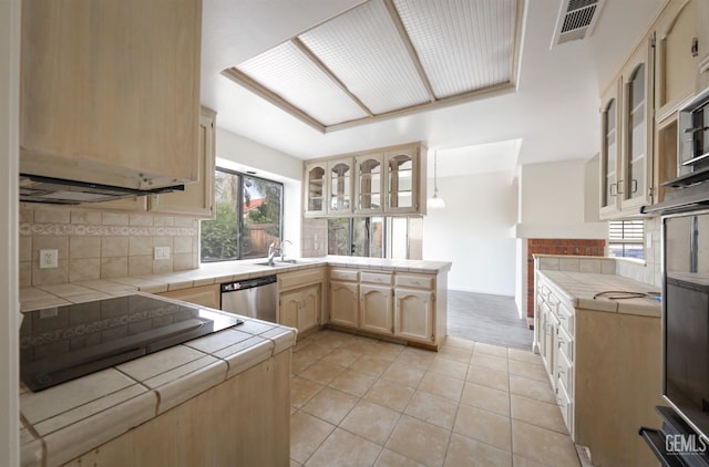 8226 Birmingham St, Bakersfield, CA 93311 - kitchen featuring tile counters, stainless steel dishwasher, a peninsula, and backsplash