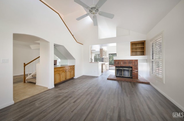 8226 Birmingham St, Bakersfield, CA 93311 - unfurnished living room with dark wood-style flooring, a ceiling fan, stairs, baseboards, and high vaulted ceiling