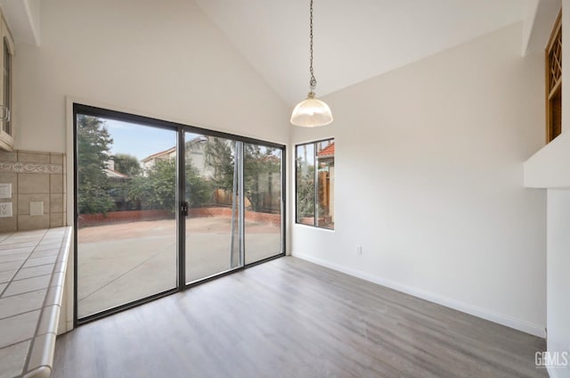 8226 Birmingham St, Bakersfield, CA 93311 - empty room with wood finished floors, high vaulted ceiling, and baseboards