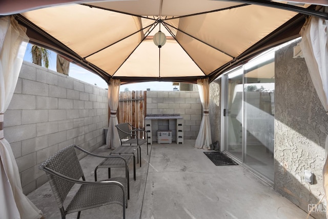 view of patio / terrace featuring fence and a gazebo