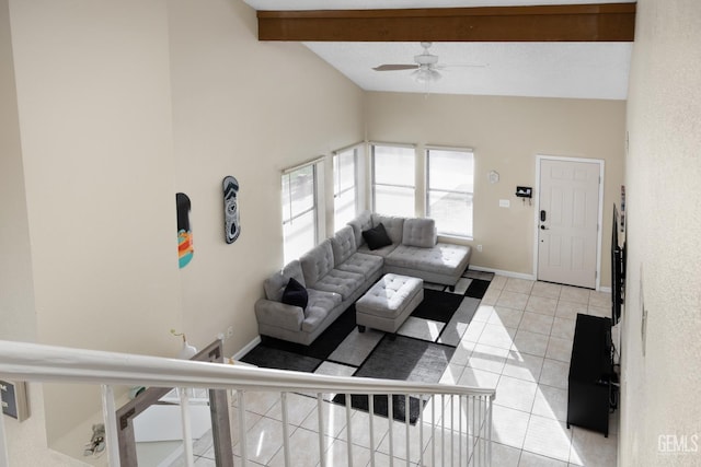 living area with light tile patterned floors, baseboards, a ceiling fan, and vaulted ceiling with beams