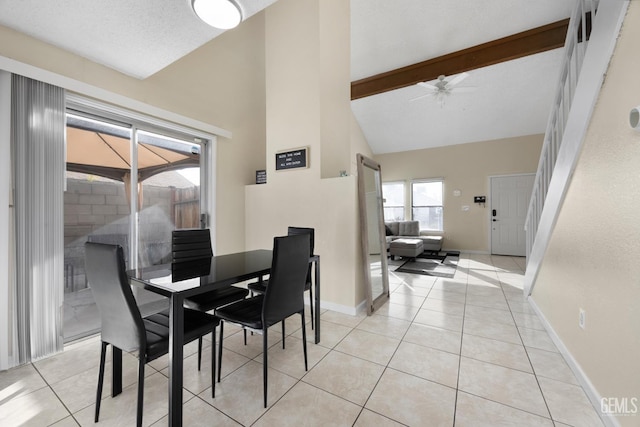 dining area with light tile patterned floors, baseboards, ceiling fan, high vaulted ceiling, and beam ceiling