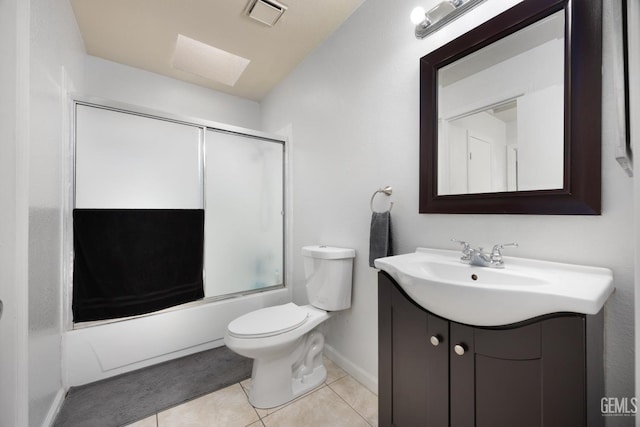 bathroom featuring visible vents, toilet, shower / bath combination with glass door, tile patterned floors, and vanity