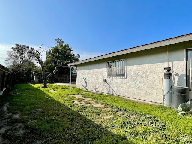 view of side of property with a lawn