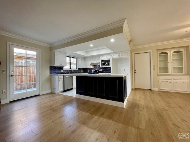 kitchen featuring backsplash, white cabinets, ornamental molding, stainless steel appliances, and light wood-type flooring