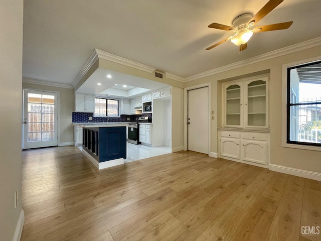 kitchen featuring stainless steel appliances, ornamental molding, white cabinets, and light hardwood / wood-style flooring